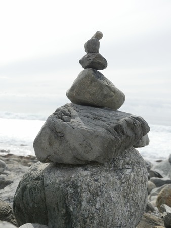 Close-up of composition of balancing rocks on ocean background