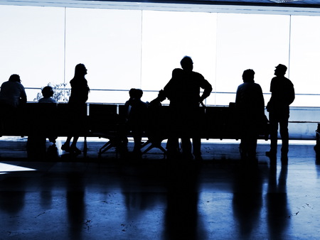 Several  silhouettes of businesspeople interacting  background business centerの写真素材