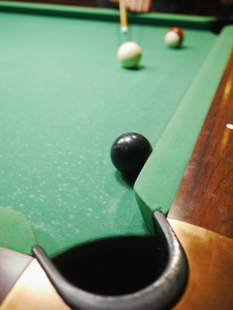 Billiard balls in a green pool tableの写真素材