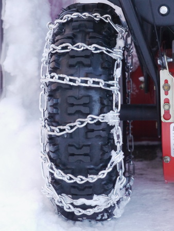 Snow chains outside at a wheel in winter