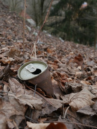 Rusty tin can on the dirty groundの写真素材