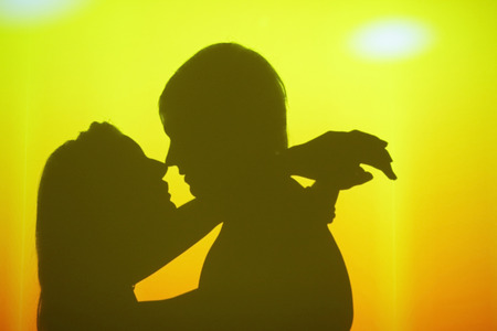 shadows of a loving couple at wall on a discoの写真素材