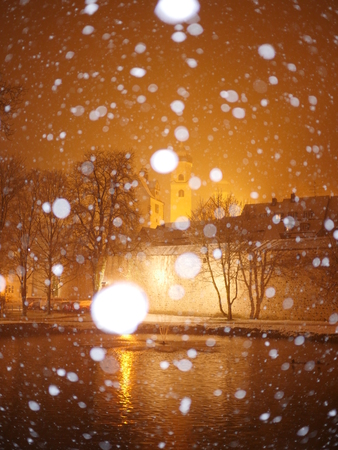 Snowfall at night street with blurred snowflakesの写真素材