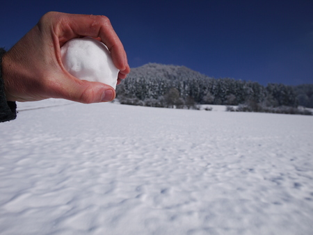 Holding snow ball in one handの写真素材