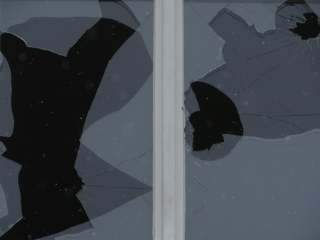 Holes in the beaten windowpaneの写真素材