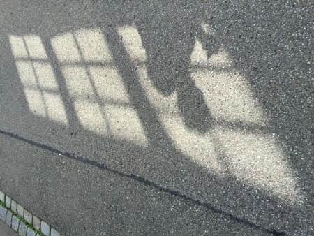 Shadow on ground of person dropped through window barsの写真素材