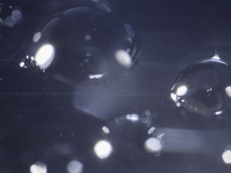 water droplets on black background with focus on the centerの写真素材