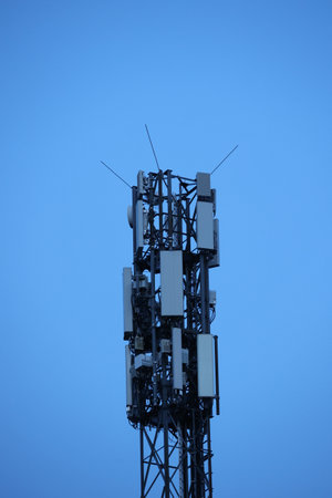 A tall tower with many antennas on topの写真素材