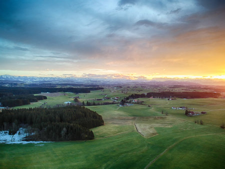 Beautiful, serene landscape with a bright orange and pink skyの写真素材