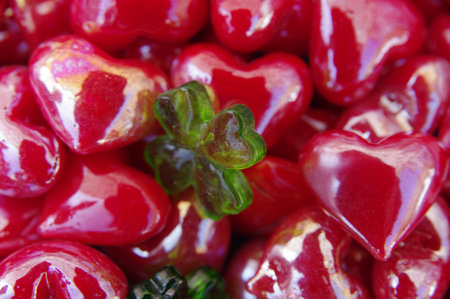 Bunch of red hearts with a green clover in the middleの写真素材