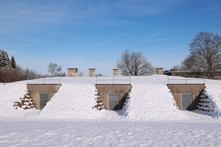 Three small buildings with a snow covered roof