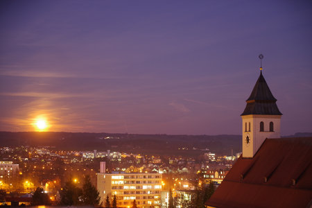 City at night with a large clock tower in the backgroundの写真素材