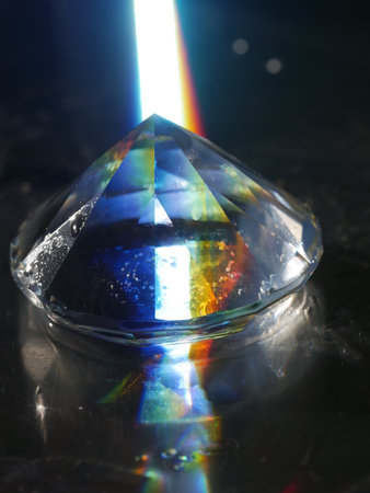 Diamond is sitting on a table with a rainbow reflected in it