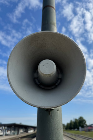 A Street Megaphone is Standing Proudly and Clearly Against a Bright Blue Sky Above Usの写真素材
