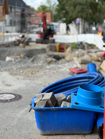 A bustling construction site with tools and equipment, surrounded by urban development