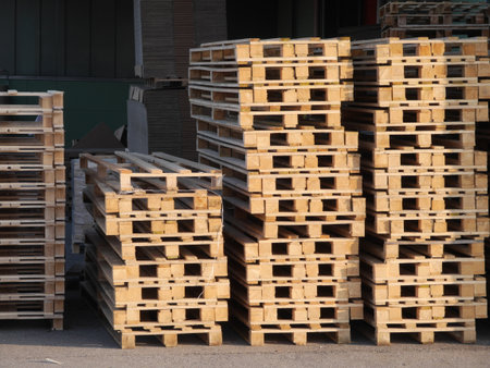 Stack of wooden pallets are piled high