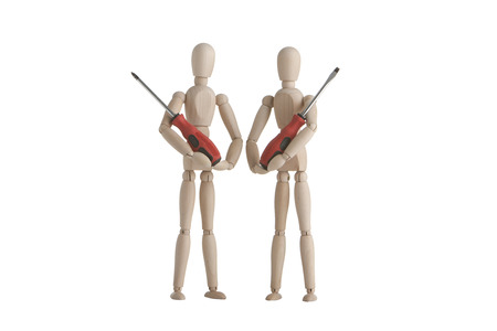 Two wooden mannequin with holding screw driverの写真素材