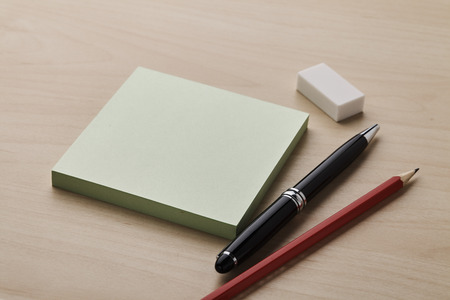 Note with pen, pencil and eraserの写真素材