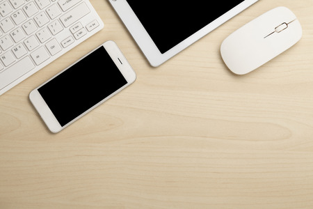 Modern working business desk with keyboard, smartphone & mouse. Top viewの写真素材