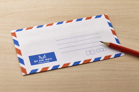 Air mail envelope on the wooden table