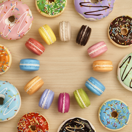 Colorful macaron and doughnut on wooden table