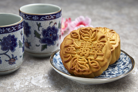 Golden Emerald mooncake on wooden table. Chinese mid autumn festival foods