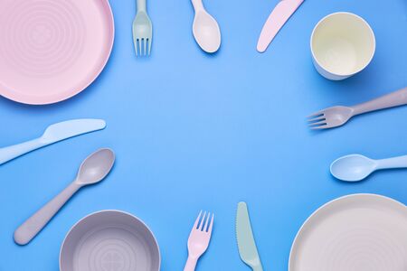 Plasic fork, spoon and knife on black background, top viewの写真素材