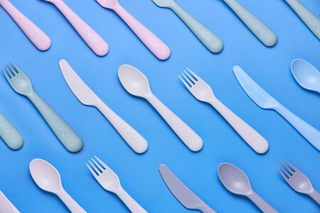 Plasic fork, spoon and knife on black background, top viewの写真素材