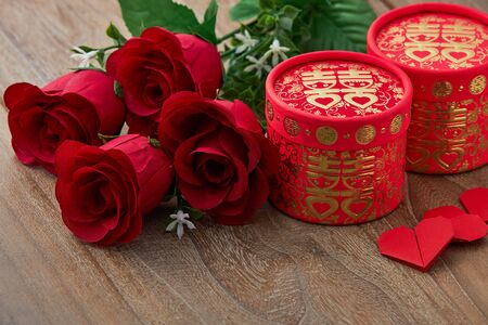 Chinese traditional wedding red heart rose on wooder table background, top view with copy spaceの写真素材