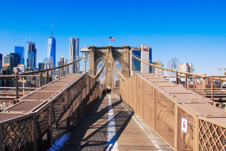 Stars and Stars fly over Brooklyn Bridge against skyscrapers in New Yorkの写真素材