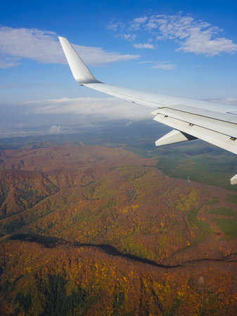 Autumn leaves of hakkoda mountain range spreading below before landing at Aomori Airportの写真素材