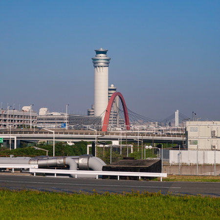 Haneda Airport control tower and red sky arch from the window to the runwayのeditorial素材