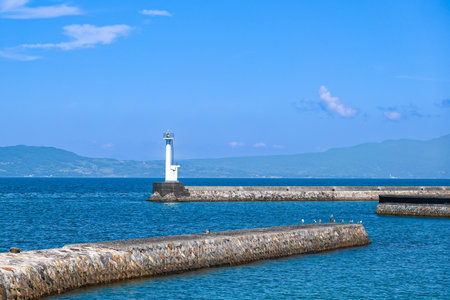 Beautiful masonry embankment Amakusa Port Kamitsuura North Breakwater Lighthouse on the Ariake Sea (Amakusa City, Kumamoto Prefecture)の写真素材