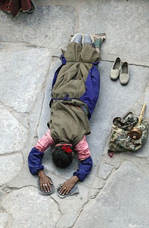 A Tibetan woman praying at Jokhang Monastry in Lhasa.の写真素材