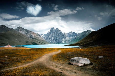 Beautiful mountain landscape with blue lake at the foot of the mountainsの写真素材