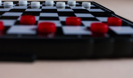 Close up of a chess board with red and white figures on itの写真素材