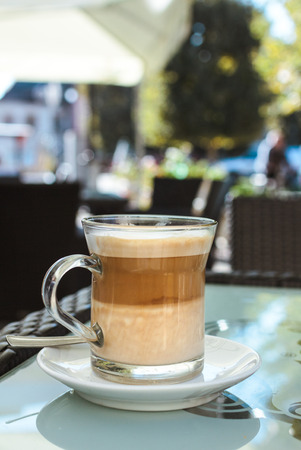 Caffe latte on a glass tableの写真素材