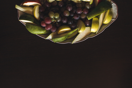 Plate of grapes and sliced apple and pearsの写真素材