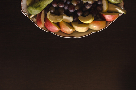 Plate of grapes and sliced apple and pearsの写真素材