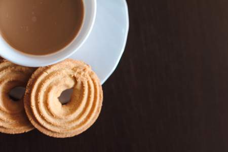 Cup of morning coffee and three round shaped biscuitsの写真素材