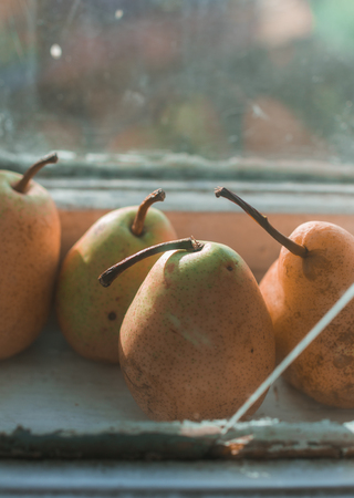 Four rie pears in the kitchen windowの写真素材