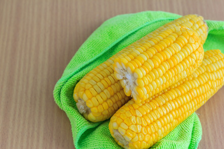 Boiled corns on wood tableの写真素材