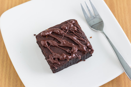 Chocolate brownie on white plateの写真素材