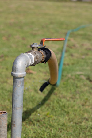Old faucet. Old rusty water tap in the yard.の写真素材