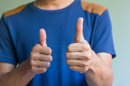 Man is showing double thumbs up