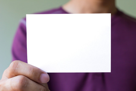 Man hand is holding the blank white cardの写真素材