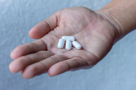 many pills in man hand