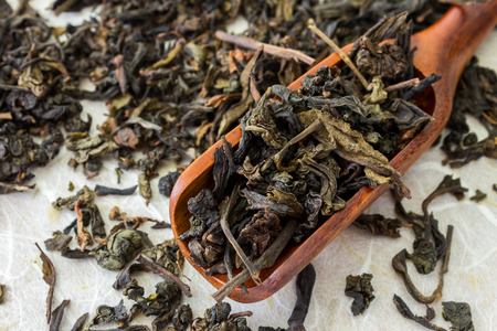 dried tea leaves in wood spoonの写真素材