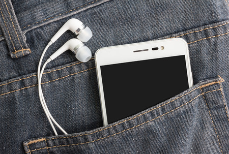 earphone and smartphone in jean pocketの写真素材