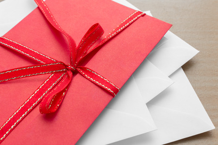 pile of envelopes with red envelope on topの写真素材